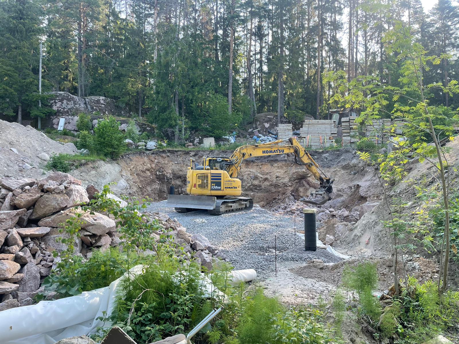 man and woman laughing while sitting in front of laptops